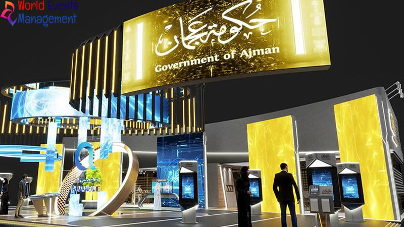 Luxury gold exhibition stand with premium branding, digital screens, and elegant product display areas
