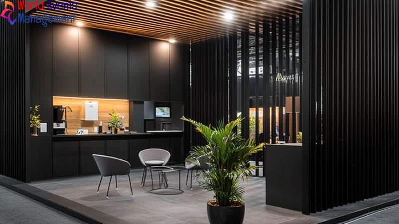 Minimal black exhibition booth interior with premium lighting and consultation area