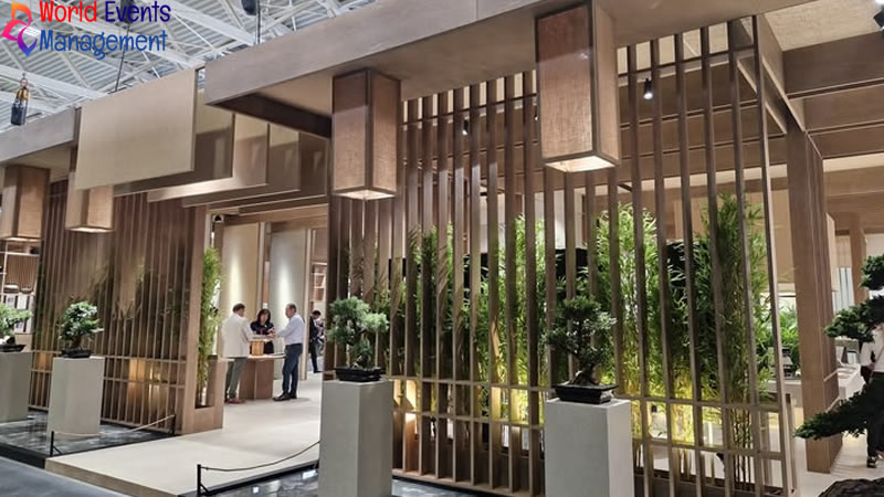 Natural wood themed exhibition booth with plants and open meeting spaces