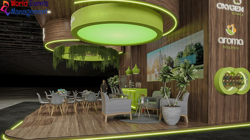 Green themed exhibition stand featuring creative lighting, modern seating, and natural design elements