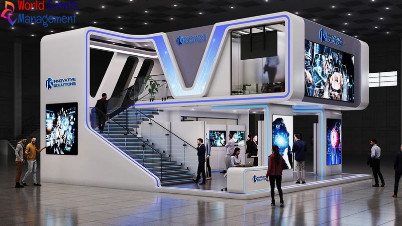 Blue futuristic exhibition stand with modern curved structure, digital screens, and open visitor areas