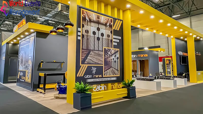 Custom yellow and black exhibition stand with branded display panels and product presentation areas
