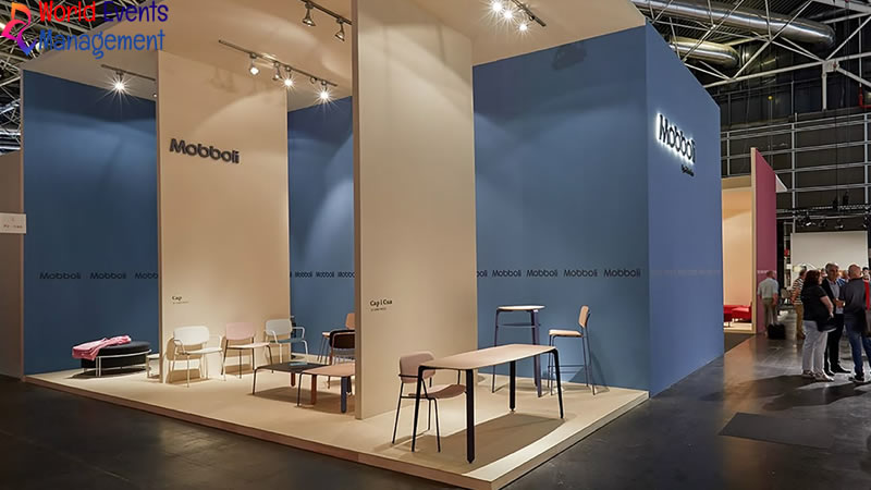Blue and white exhibition stand design with meeting area and branded displays