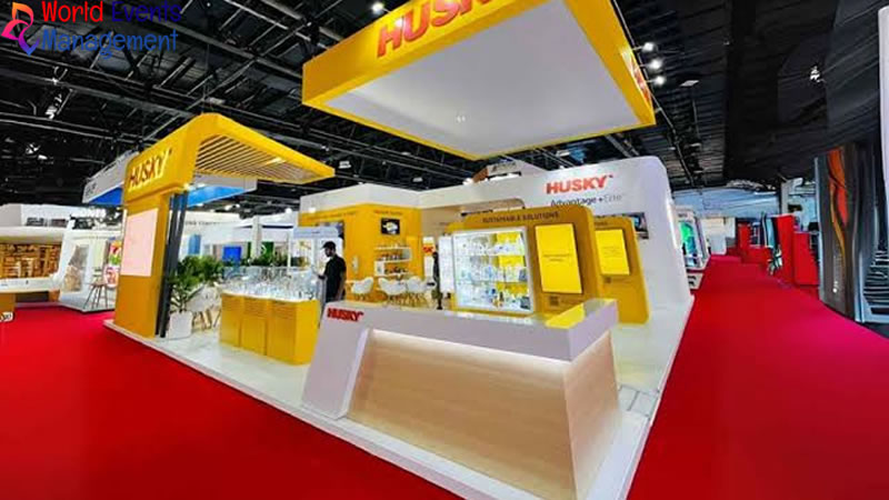 Yellow and white branded exhibition stand with open counters and product display areas