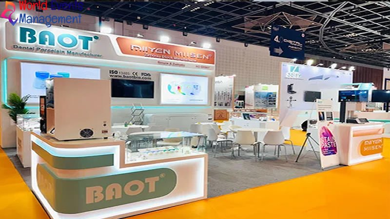 Professional exhibition booth setup with branded display counter and visitor seating area